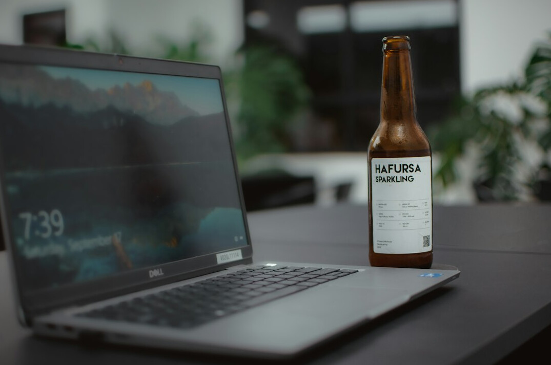 Hands typing on a laptop showing a sales growth dashboard